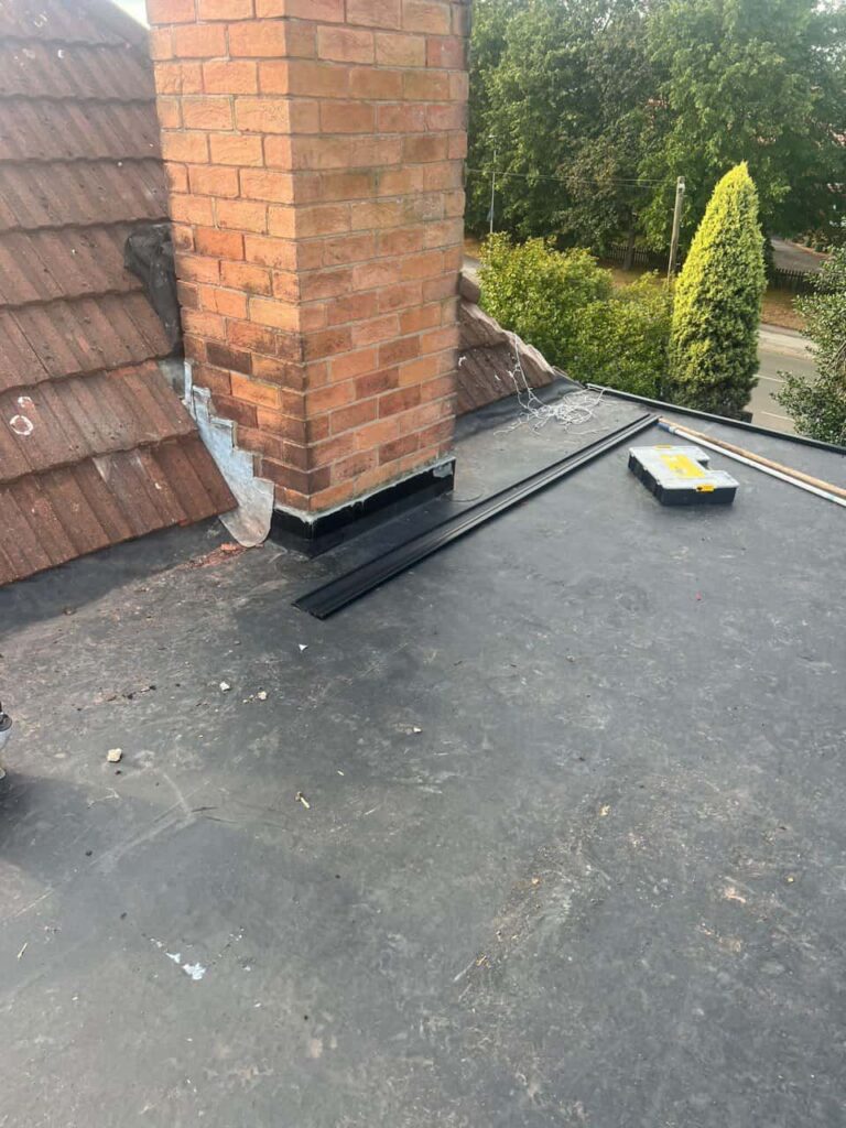 This is a photo of a flat roof which has just been repaired, there is also a chimney stack and some leadwork has also been dressed. Works carried out by Giltbrook Roofing Repairs